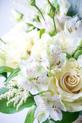 beautiful wedding bouquet with white roses and other flowers on wooden background  with 2 wooden pigeons