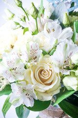 beautiful wedding bouquet with white roses and other flowers on wooden background  with 2 wooden pigeons