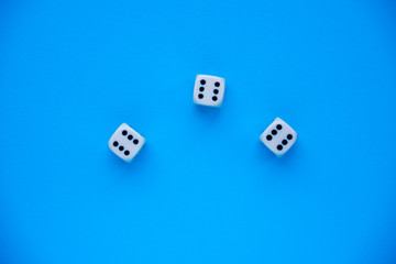 dice on a blue background, three sixes