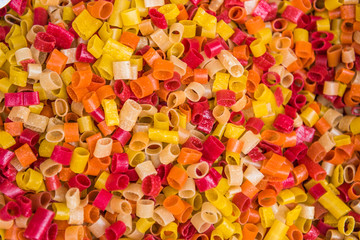 Red, orange and yellow dried pasta at Bhaktapur market, Nepal