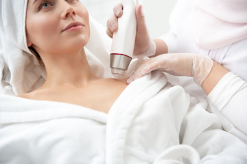 Beautician hand cleaning female body with special equipment in doctor office. Skin care concept