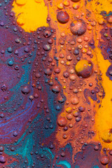Mars-like landscape created with several paints on Glycerine which are forming little colorful balls and isles