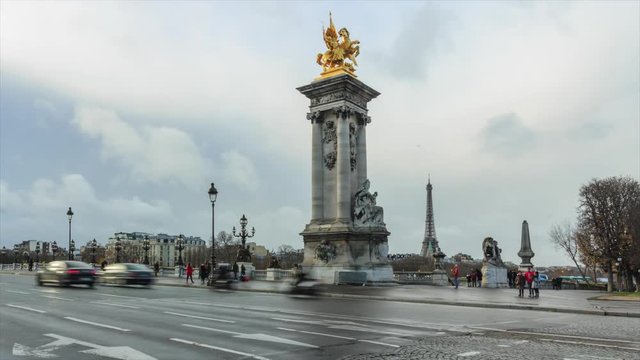 Paris street traffic time lapse during rush hours on the bridge Alexandre III. Cityscape with the Eiffel tower, urban transportation, tourism concept. Famous touristic places and landmarks in France