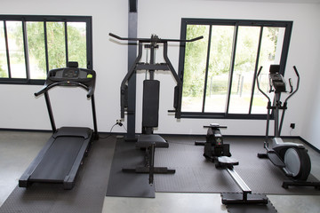 Fototapeta na wymiar Fitness club with different machines in the gym equipment for training exercise