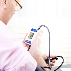Man read measurement result from digital blood pressure monitor