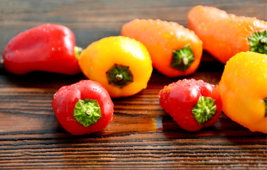 colorful of chili with water drop on wooden background.
Many color mixed paprika.