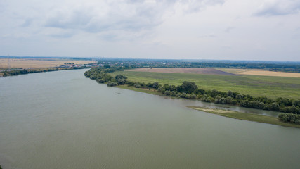Russian forest, river, roads under blue sky by aerial drone. Stunning Aerial Drone Stock Photo of South russian forest, river, roads.