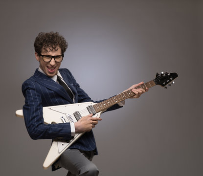 Funny man playing electric guitar