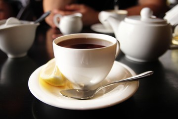 The cup of black tea with lemon