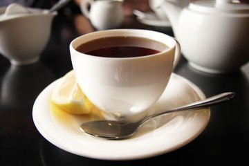 The cup of black tea with lemon