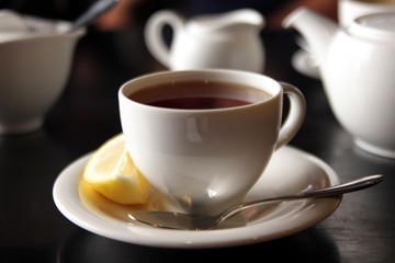 The cup of black tea with lemon