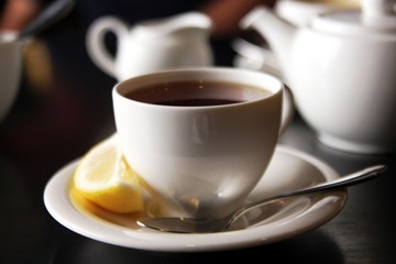 The cup of black tea with lemon