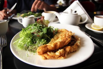 Omlette with mushrooms and lettuce - traditional european breakfast
