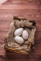 Three big fresh goose eggs in a box, copyspace