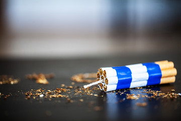 Stop smoking concept on background with broken cigarettes. Heap of cigarettes. No smoking