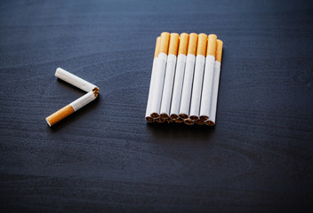 Stop smoking concept on background with broken cigarettes. Heap of cigarettes. No smoking