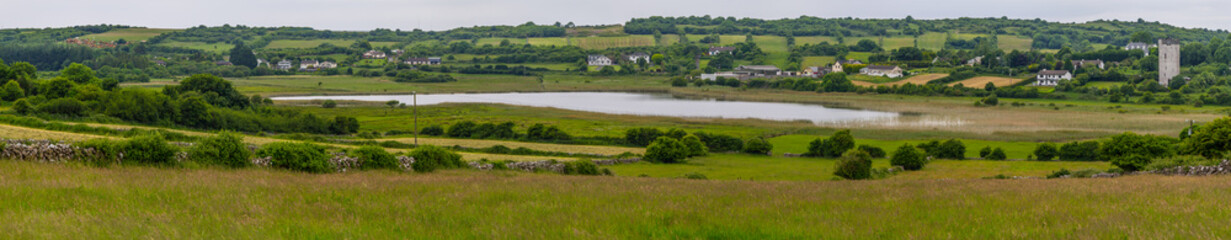 Fototapeta na wymiar Ballindooley Castle tower with lake and meadows