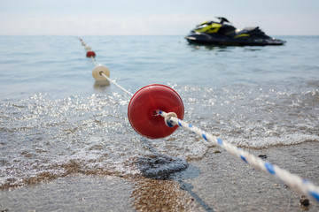 Rope with floats in the sea. Fencing of the territory.