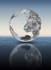 Fototapeta premium Western Sahara on translucent globe above water