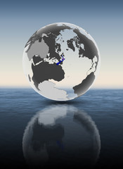 Fototapeta premium New Zealand on translucent globe above water