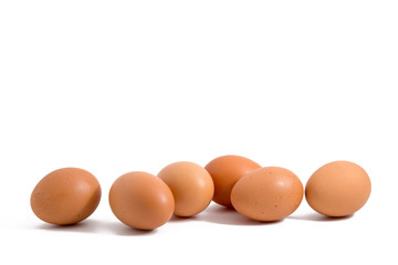 six eggs in a row on white background