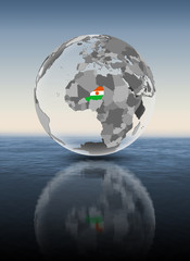 Fototapeta premium Niger on translucent globe above water