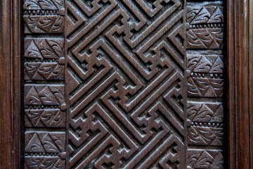 detail of old decorative wooden panel in bali indonesia