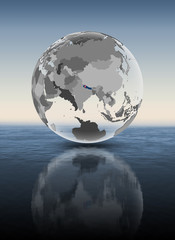 Nepal on translucent globe above water