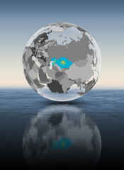 Naklejka premium Kazakhstan on translucent globe above water