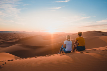 Watching the sunset in Sahara - obrazy, fototapety, plakaty