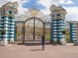 Woman tourist in a tourist spot at the Golden gate of the Grand Catherine Palace in Tsarskoye Selo,...