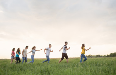 Group of people running in the grass,