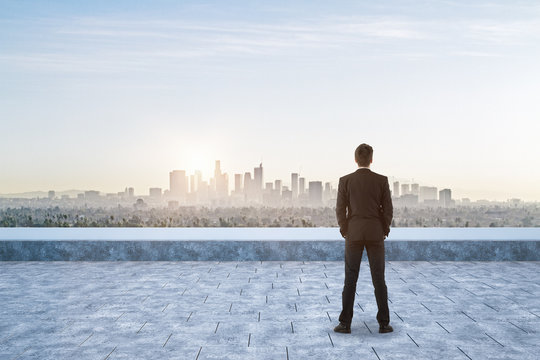 businessman on roof at city background