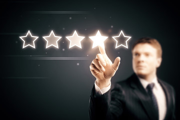 businessman pointing 5 star symbol