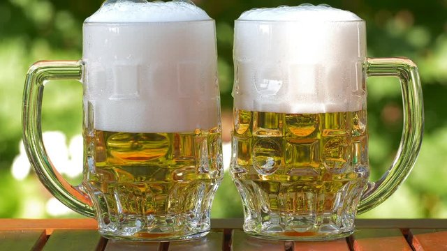 Outdoor UHD closeup shot of two glasses of lager beer