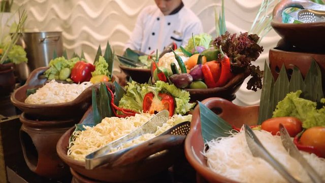 Noodles corner buffet with vegwtables, chef cooking