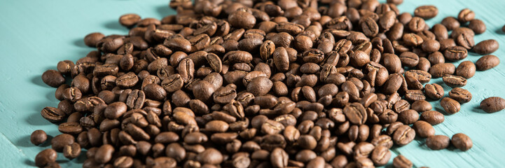 Pile of coffee granules on a blue wooden desk