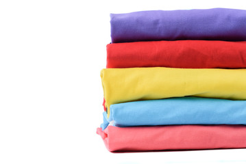 Stack of Colorful cotton T shirt isolated on white background.