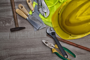 Standard construction safety equipment on wooden table. top view