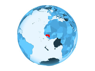 Guinea on blue globe isolated