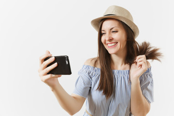 Young beautiful woman dressed blue dress, hat doing selfie shot on mobile phone or video call isolated on white background. People, sincere emotions, lifestyle concept. Advertising area. Copy space.