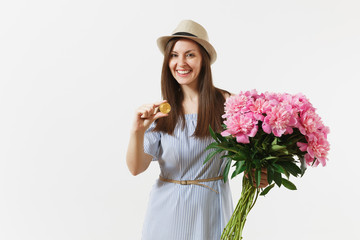 Young woman in dress, hat holding bitcoin, coin of golden color, bouquet of beautiful pink peonies flowers isolated on white background. Business, delivery, online shopping, virtual currency concept.