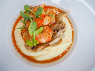 Dish of shrimps, mushrooms and mashed potatoes