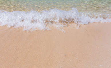Fototapeta na wymiar Crashing wave and white sand beach at Railay beach, Krabi, Thailand.