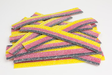striped gummy candy in black, red and yellow