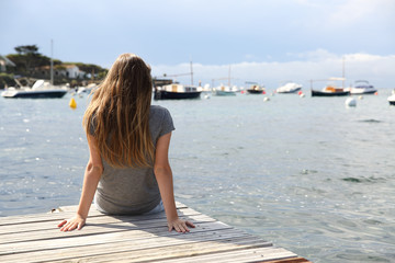 Woman alone contemplating the sea on summer