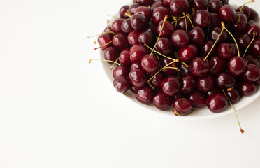 Fresh cherry on plate on wooden white background. fresh ripe cherries. sweet cherries.
