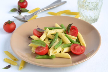 Penne pasta with green beans, cherry tomatoes and basil