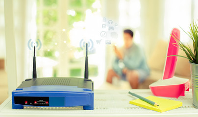 closeup of a wireless router on living room at home with a window in the background