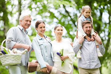 Contempolrary family in casualwear going for picnic in natural environment